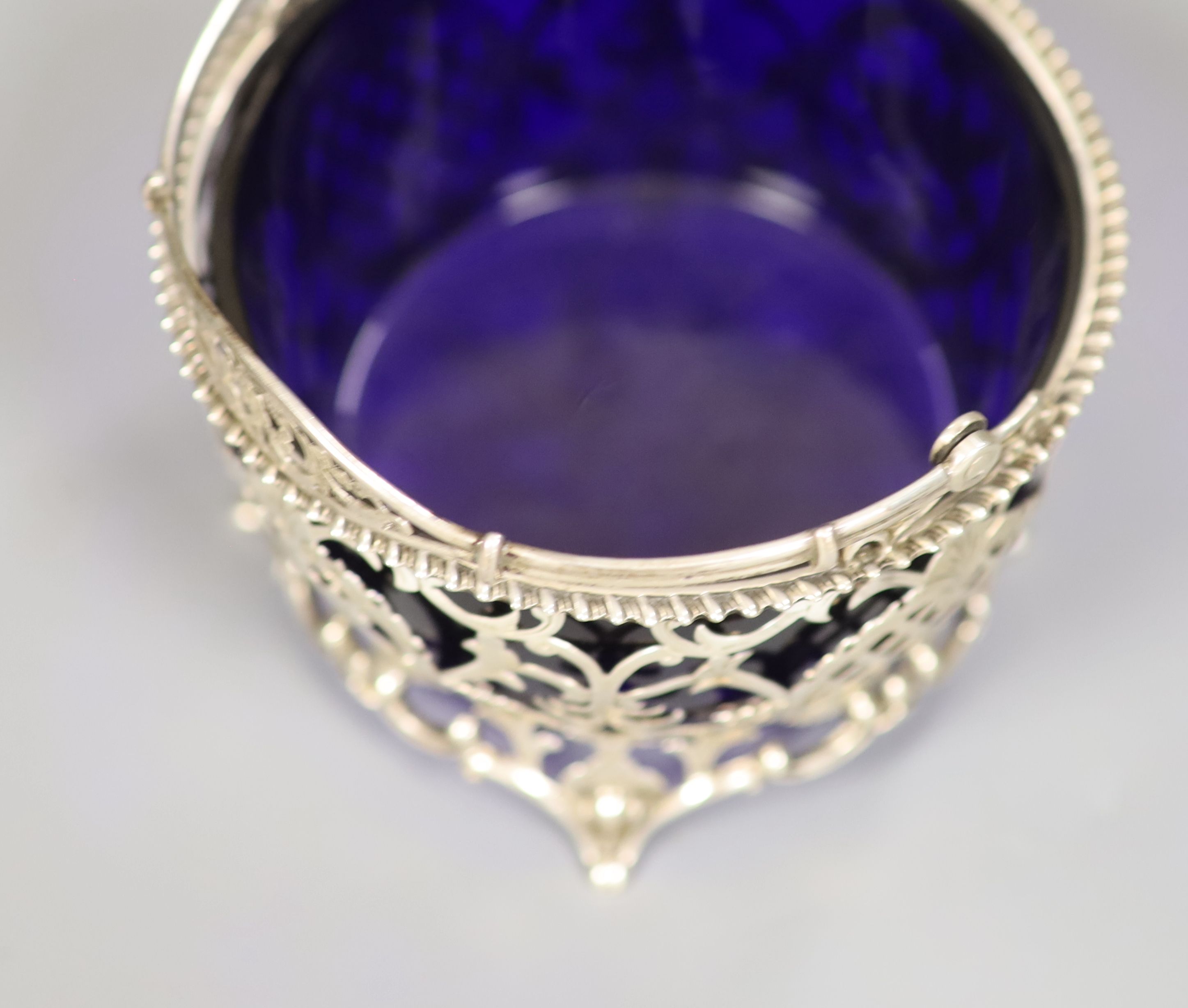 An Edwardian silver sugar basket with blue glass liner, Robert William Jay, Birmingham,1910, diameter 10.9cm,